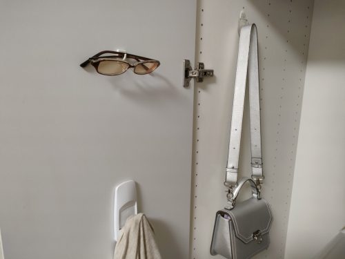 Pictures of bags and glasses hanging on hooks